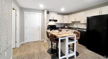 North Cowichan apartment for rent - A kitchen with a table and chairs in the middle of the room.