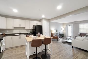 North Cowichan apartment for rent - A modern kitchen with a dining table and chairs.