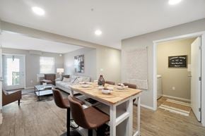 North Cowichan apartment for rent - A dining room with a table set for two and a couch in the background.