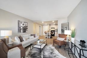 North Cowichan apartment for rent - A modern living room with a white couch, a coffee table, and a rug.