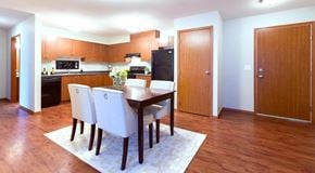 Winnipeg apartment for rent - A kitchen with a dining table and chairs.