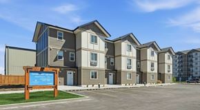 Lethbridge apartment for rent - A row of townhomes with parking out front