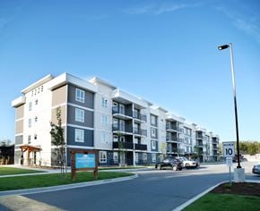 Campbell River apartment for rent - A modern apartment building with a sign that reads "FORCE APARTMENTS" in front of it.