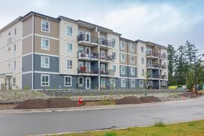 Parksville apartment for rent - Apartment building with balconies and a fire hydrant in front.