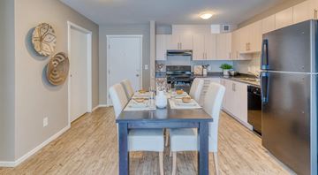 Edmonton apartment for rent - A modern kitchen with a dining table set for two.