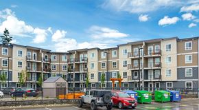 Parksville apartment for rent - A large apartment building with parking, and community garden in front
