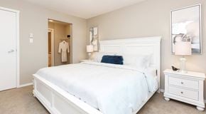 Kelowna apartment for rent - A queen sized bed with night stands, a walk in closet and ensuite