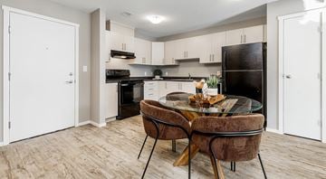 Lethbridge apartment for rent - A modern kitchen with a glass table and chairs.