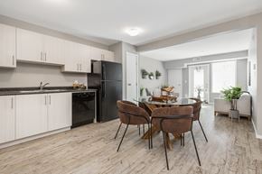 Edmonton apartment for rent - A modern kitchen with a dining table set for four.