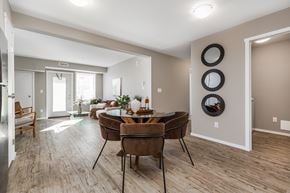 Edmonton apartment for rent - A modern dining room with a wooden table and chairs.