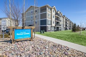 Red Deer apartment for rent - A rental centre sign is in front of apartment buildings.