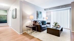 Beaumont townhouse for rent - Apartment living room with couch, coffee table and end table. with large glass sliding door