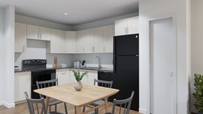 Ottawa apartment for rent - A kitchen with a black refrigerator and a wooden dining table with grey chairs.