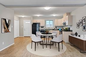 Campbell River apartment for rent - A modern kitchen with a dining table and chairs in the middle.