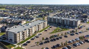 Red Deer apartment for rent - A large apartment complex with a parking lot in front.