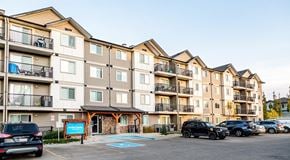 Edmonton apartment for rent - Apartment complex with cars parked in front.