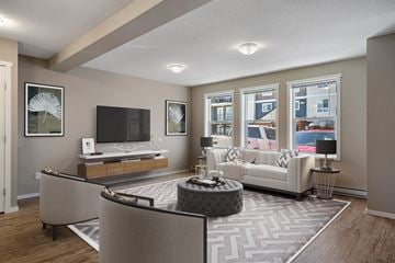 Cranbrook townhouse for rent - A living room with a white couch and a television.
