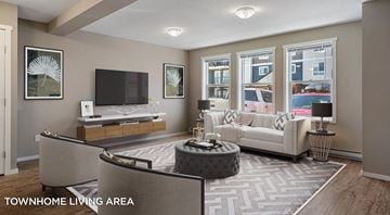 West Kelowna townhouse for rent - A living room with a grey sofa and a television.