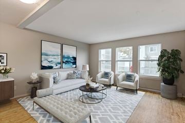 Campbell River apartment for rent - A living room with a grey rug and a white couch.