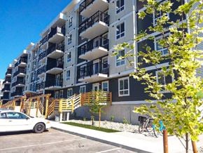 North Cowichan apartment for rent - A white car is parked in front of a multi-story building.