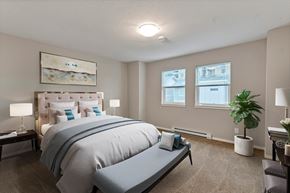 Campbell River apartment for rent - A bedroom with a large bed and a painting on the wall.