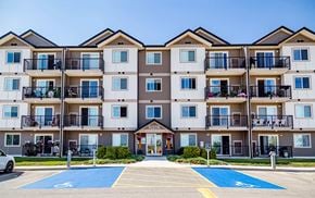Selkirk apartment for rent - A large apartment complex with a parking lot in front.