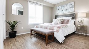 Selkirk apartment for rent - A bedroom with a queen sized bed,  night stands and large window