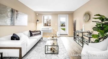 Campbell River apartment for rent - Apartment living area with a white couch, coffee table, and a painting on the wall.