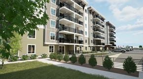 Orleans apartment for rent - A modern apartment building with balconies and a parking lot in front.