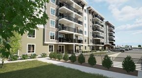 Orleans apartment for rent - A modern apartment building with balconies and a landscaped front yard.