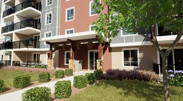 Orleans apartment for rent - A modern apartment building with a landscaped front yard.