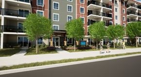 Orleans apartment for rent - A modern apartment complex with balconies and trees in front.