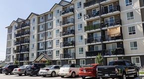 Penticton apartment for rent - A large six storey apartment building with cars in front