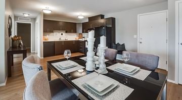 Edmonton apartment for rent - A modern dining room with a black table set for two.