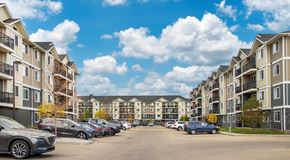 Edmonton apartment for rent - A large apartment complex with parking in between the buildings