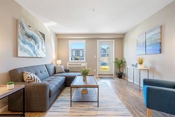 Cranbrook apartment for rent - A living room with a grey couch and a coffee table.