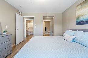Cranbrook apartment for rent - A bedroom with a large bed and a painting on the wall.