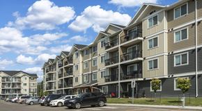 Edmonton apartment for rent - An apartment complex with cars parked in front.