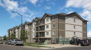 Edmonton apartment for rent - A apartment building with cars parked in front.