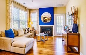 Hanover townhouse for rent - A living room with a fireplace and a large mirror on the wall.
