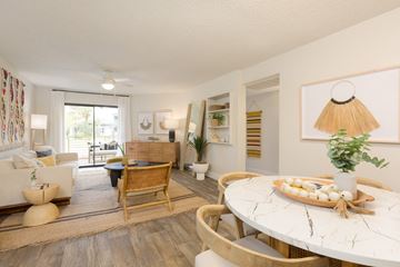 Mesa apartment for rent - A living room with a white table and a wooden chair.