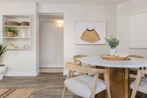 Mesa apartment for rent - a small dining area with a round table and wooden chairs