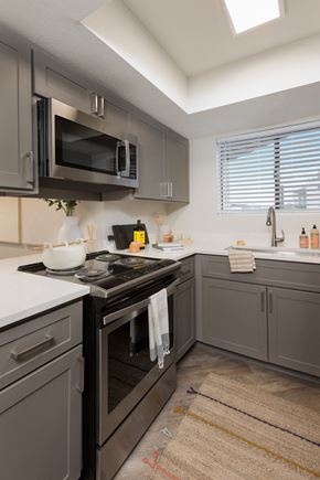 Mesa apartment for rent - a kitchen with gray cabinets and white countertops