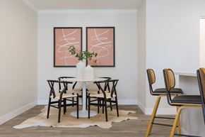 Tempe apartment for rent - a dining room with a table and chairs and two paintings on the wall
