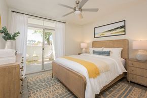 Tempe apartment for rent - a bedroom with a bed and a ceiling fan
