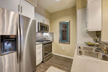 Kitchen with stainless steel appliances and white cabinets 