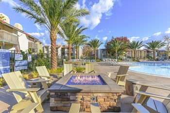 Fire pit with chairs by pool