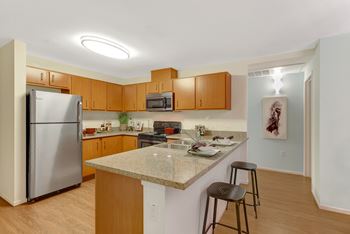 Kitchen with granite counter top and stainless steel appliances