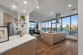 San Diego apartment for rent - Open kitchen and living area with skyline views in a modern San Diego high-rise apartment at Stanza Little Italy.
