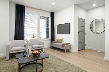 Saratoga Springs townhouse for rent - a living room with two chairs and a table and a television